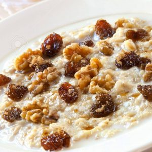 9674005-Oatmeal-topped-with-raisins-walnuts-and-brown-sugar-Delicious-healthy-porridge--Stock-Photo
